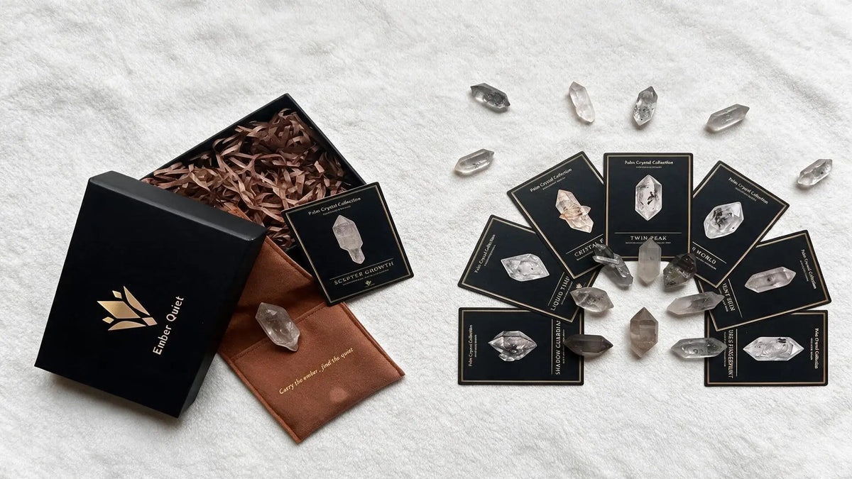 Double-terminated quartz pocket crystals arranged with eight form specimen collector cards and Ember Quiet keepsake gift box.