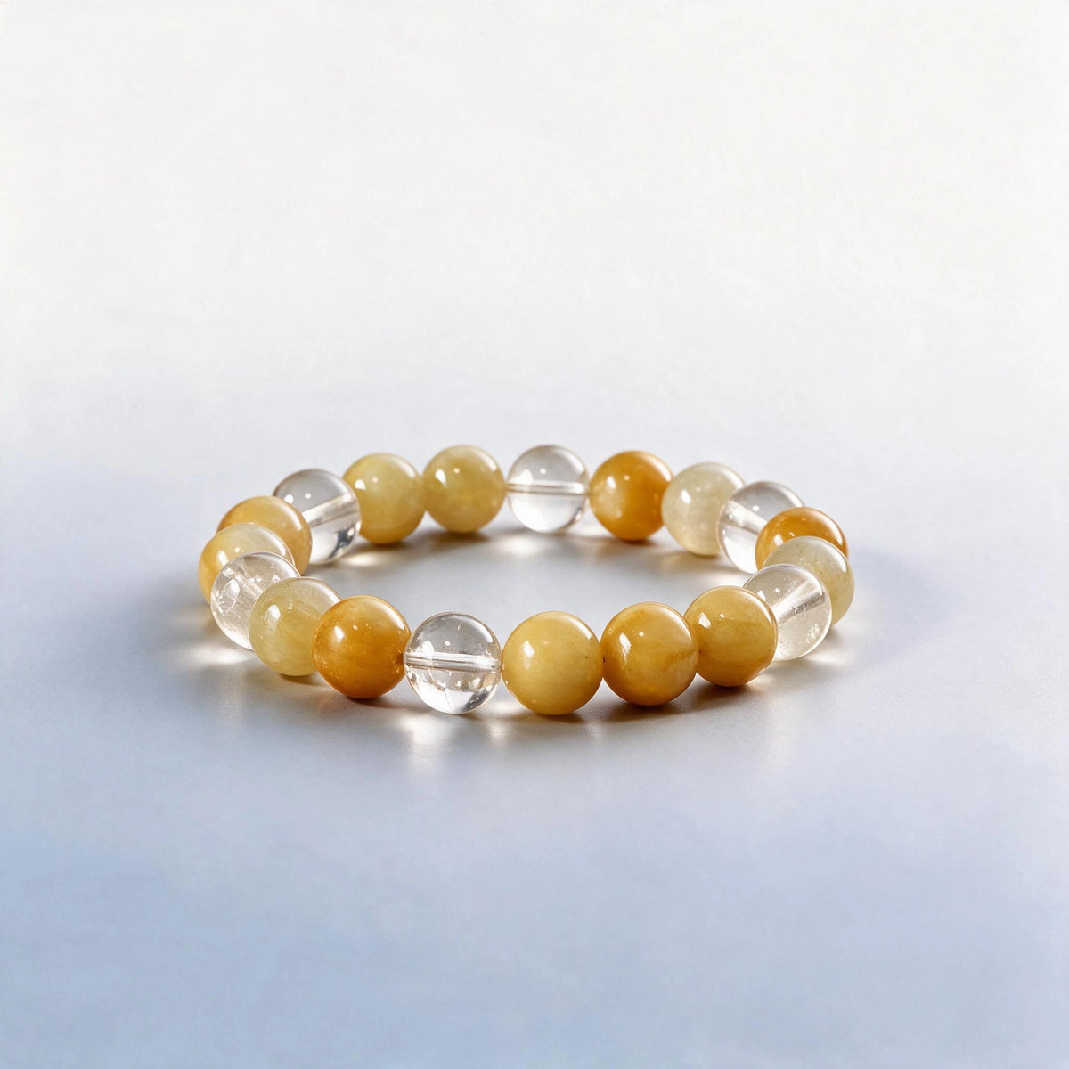Handcrafted Solar Plexus & Crown bracelet featuring Gobi golden silk jade and clear quartz beads by Ember Quiet.