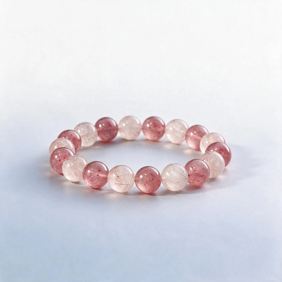 Handcrafted Heart Chakra bracelet featuring pink rutilated quartz and strawberry quartz by Ember Quiet.