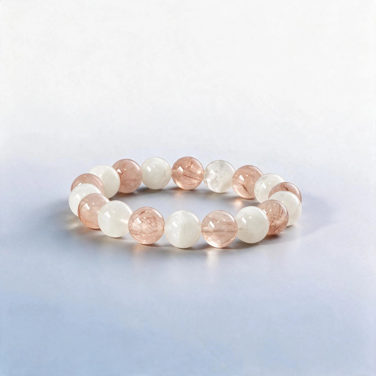Handcrafted Crown & Heart Chakra bracelet featuring natural white phantom and pink rutilated quartz by Ember Quiet.