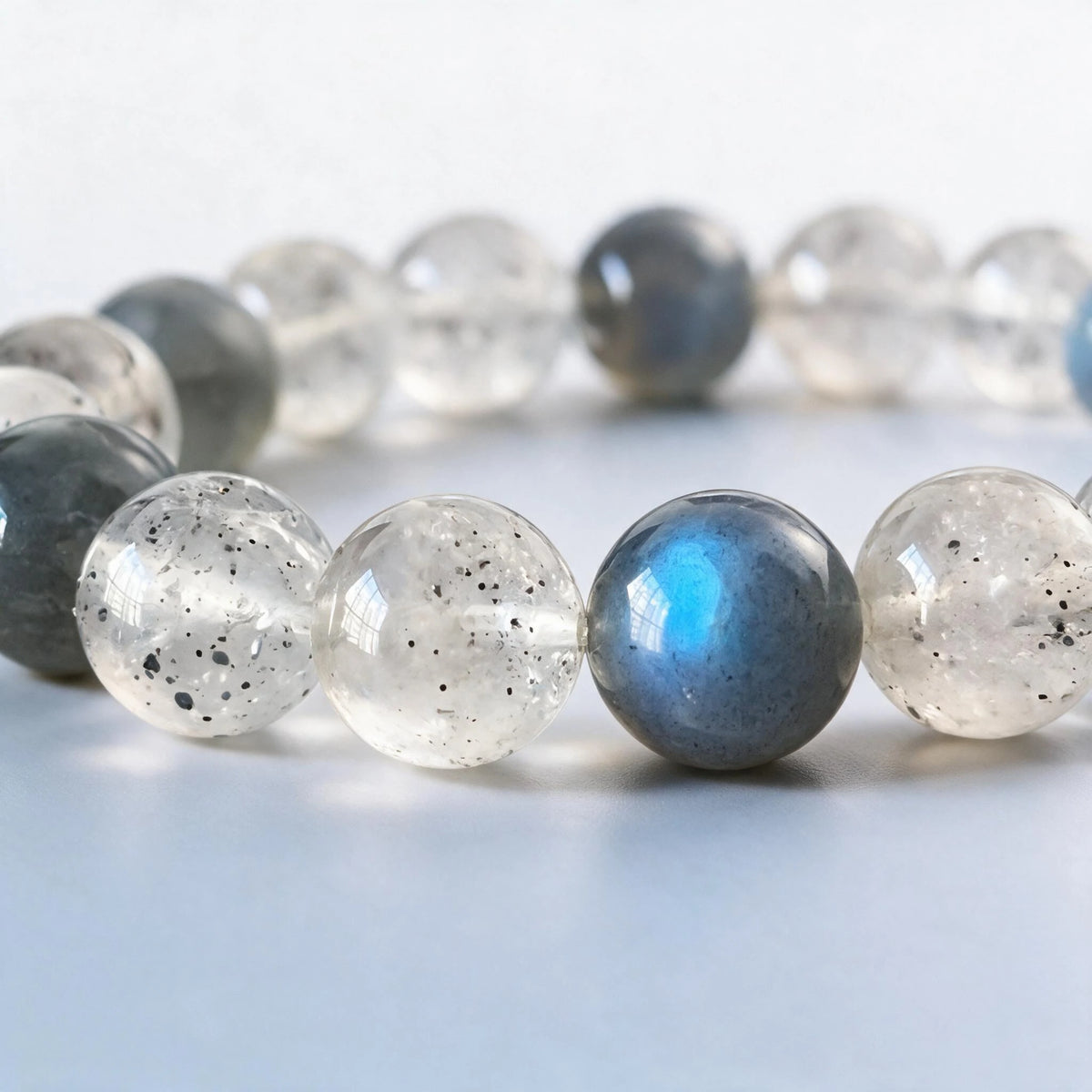 Macro close-up of authentic natural labradorite blue flash and black strawberry quartz inclusions by Ember Quiet.