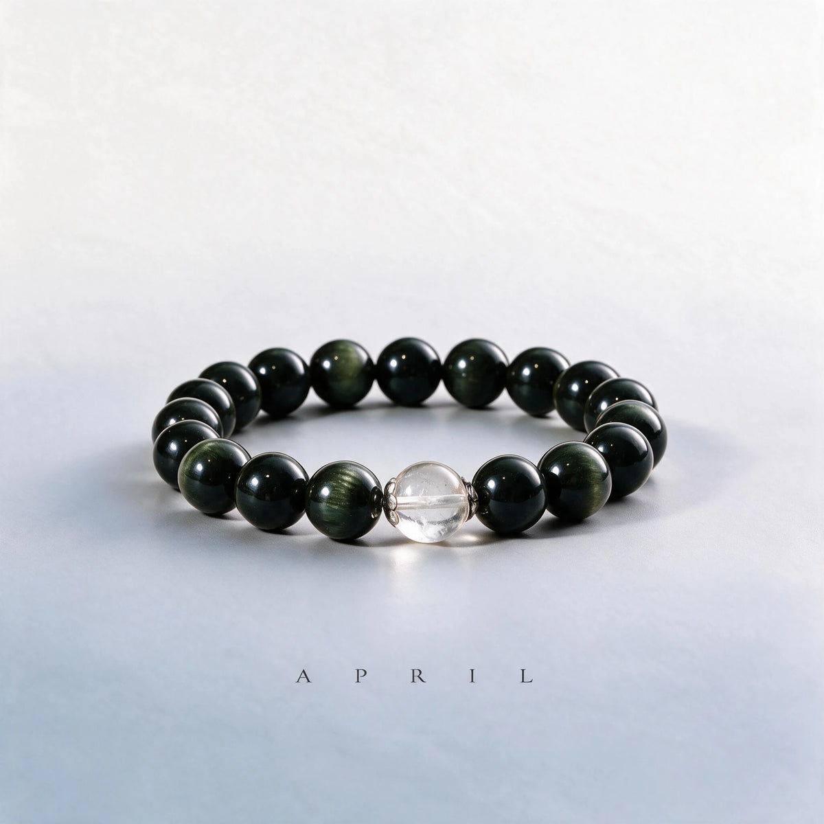 Custom April birth month Root & Solar bracelet with black and gold sheen obsidian, and clear quartz as a meaningful gift.