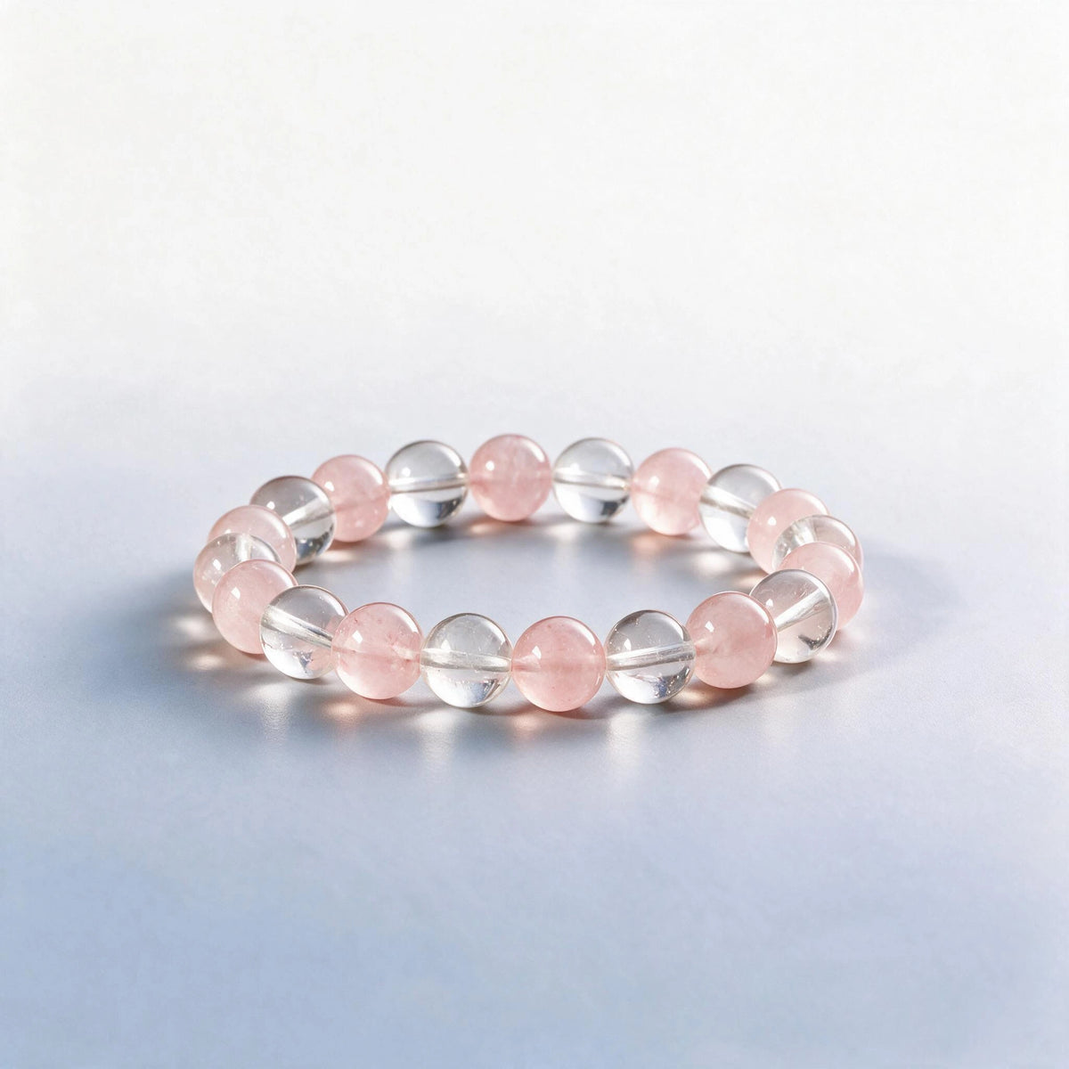 Handcrafted Crown & Heart Chakra bracelet featuring clear quartz and rose quartz beads by Ember Quiet.
