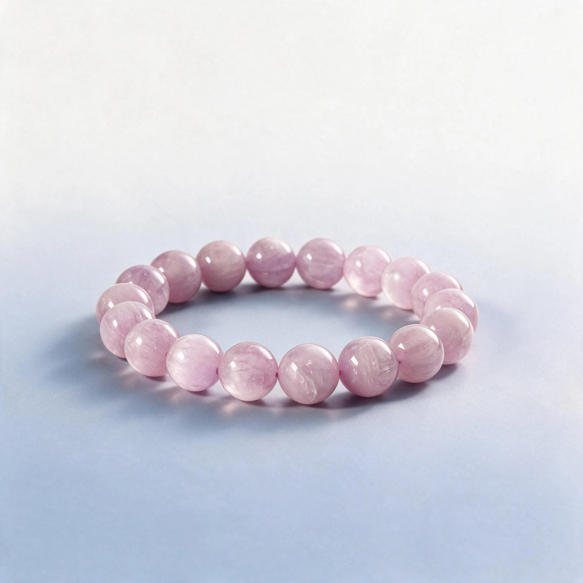 Handcrafted Heart & Crown Chakra bracelet featuring natural lilac kunzite beads by Ember Quiet.
