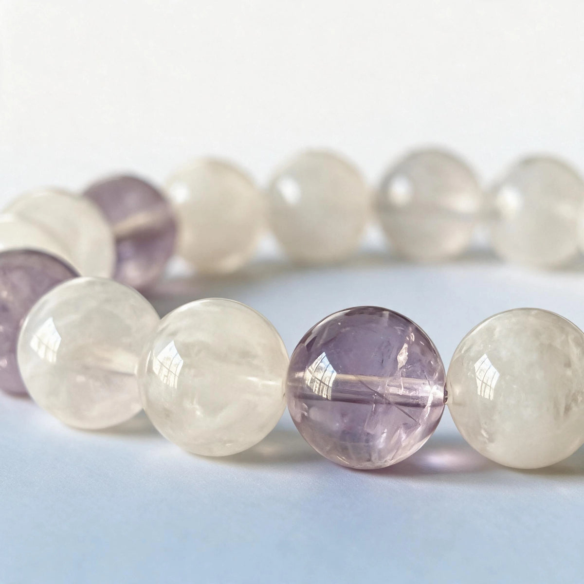 Macro close-up of authentic natural lavender amethyst and white phantom quartz inclusions by Ember Quiet.