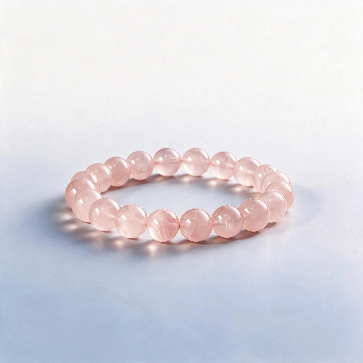Handcrafted Heart Chakra bracelet featuring natural translucent pink rose quartz beads by Ember Quiet.