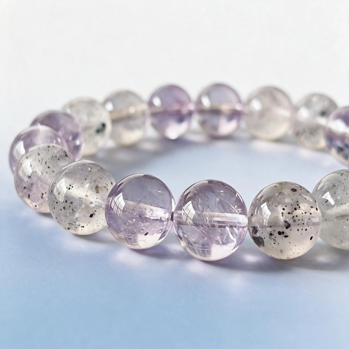 Macro close-up of authentic natural lavender amethyst and black strawberry quartz stardust inclusions by Ember Quiet.