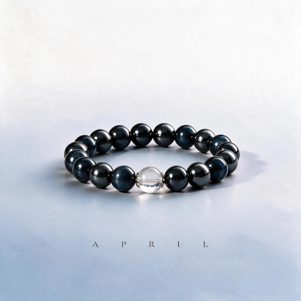 Custom April birth month Third Eye & Root bracelet with blue hawk's eye, hematite, and clear quartz as a meaningful gift.