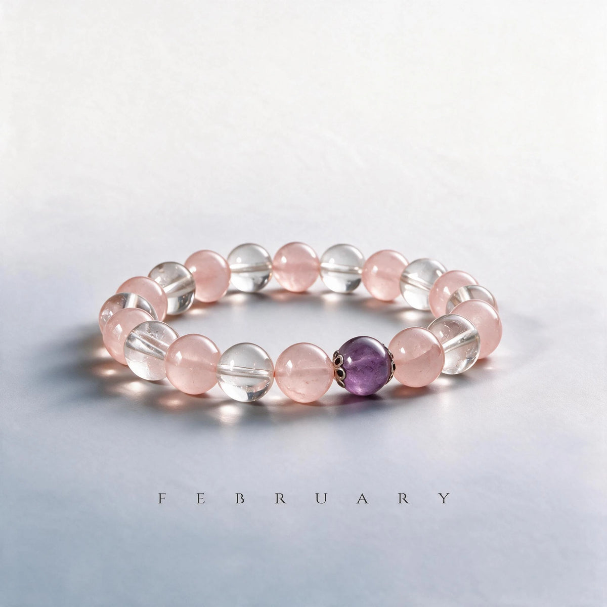 Custom February birth month Crown & Heart bracelet with clear quartz, rose quartz, and amethyst as a meaningful gift.