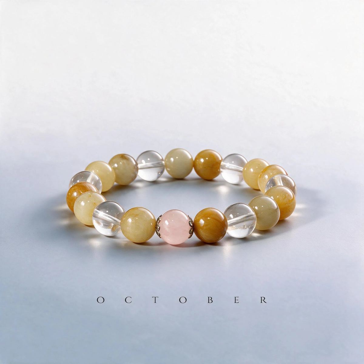 Custom October birth month Solar Plexus bracelet with golden silk jade, clear quartz, and rose quartz as a meaningful gift.