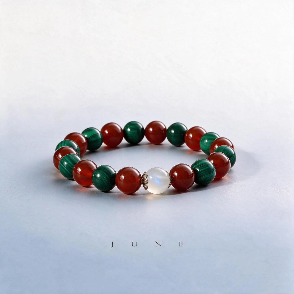 Custom June birth month Heart & Root chakra bracelet with malachite, red agate, and moonstone as a meaningful gift.