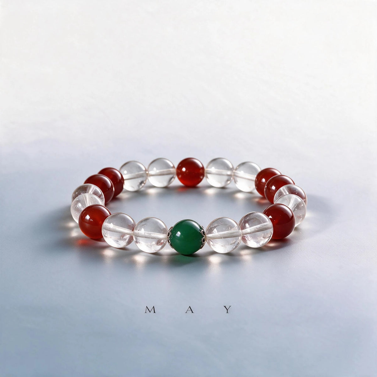 Custom May birth month Crown & Root chakra bracelet with clear quartz, red agate, and green grossular as a meaningful gift.