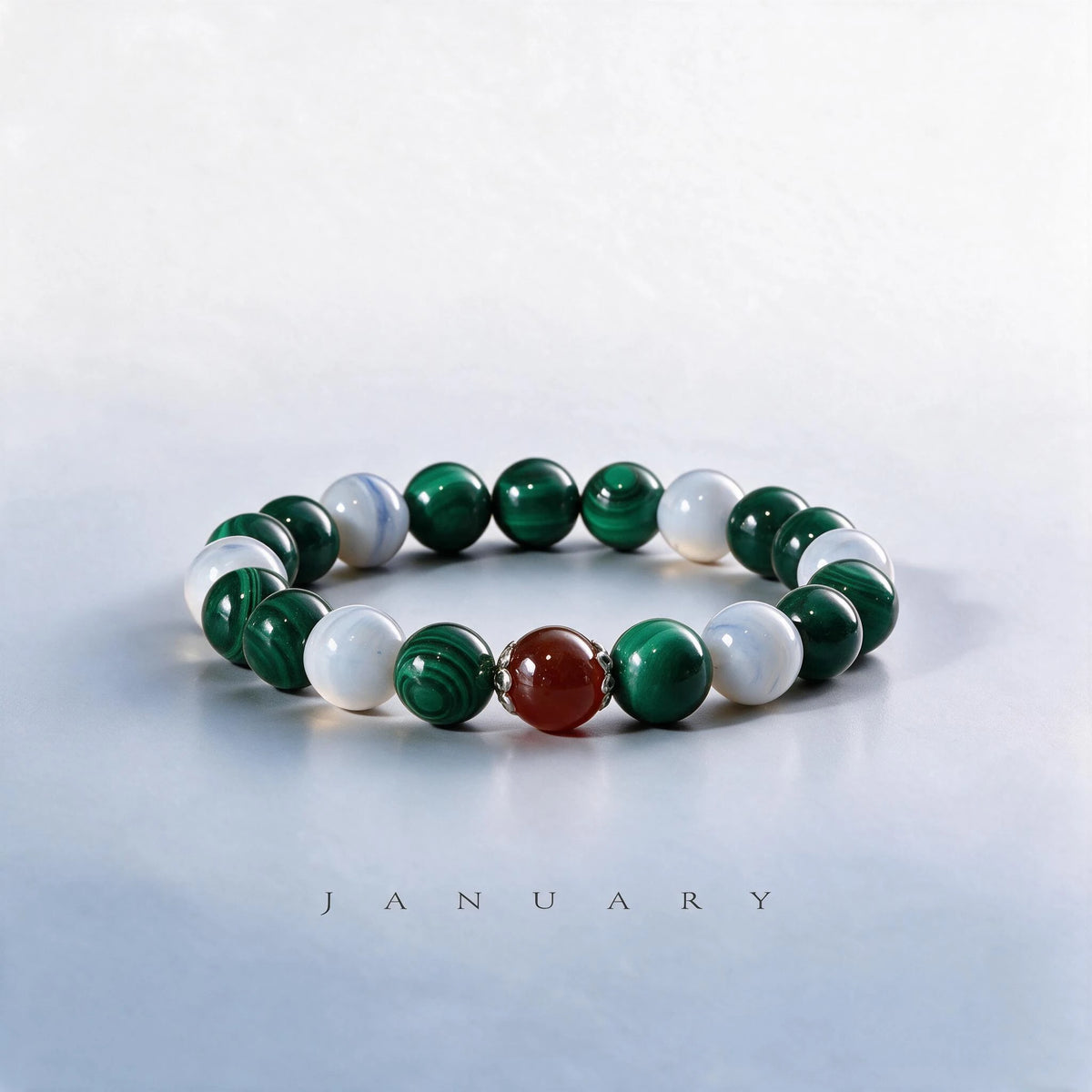 Custom January birth month Heart Chakra bracelet with green malachite, white agate, and red garnet as a meaningful gift.