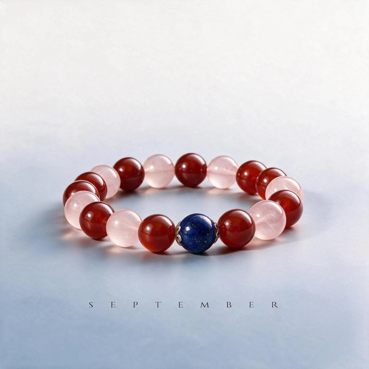 Custom September birth month Root & Heart chakra bracelet with red agate, rose quartz, and lapis lazuli as a meaningful gift.